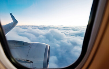 Airplane engine and wings on the sky