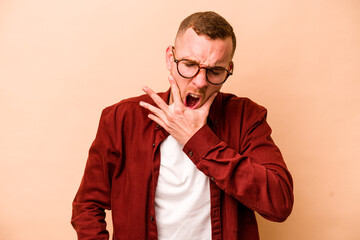 Fototapeta premium Young caucasian man isolated on beige background having a strong teeth pain, molar ache.