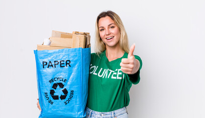 blonde pretty woman feeling proud,smiling positively with thumbs up. recycle concept