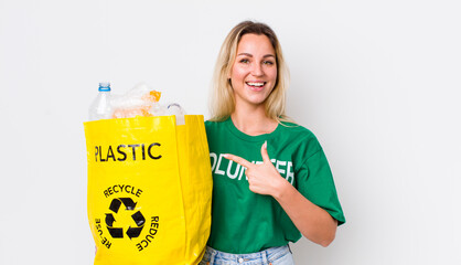 blonde pretty woman looking excited and surprised pointing to the side. recycle concept