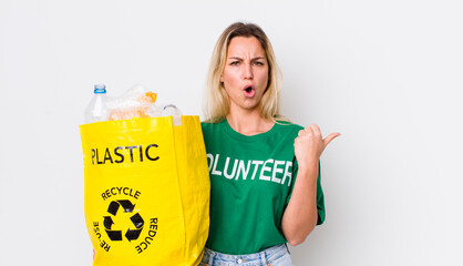 blonde pretty woman looking astonished in disbelief. recycle concept