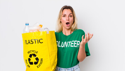blonde pretty woman amazed, shocked and astonished with an unbelievable surprise. recycle concept