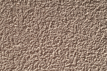 The surface of rough decorative sand-colored plaster