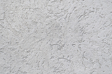 The surface of rough decorative sand-colored plaster