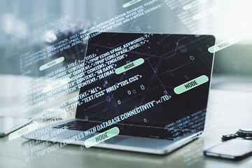Double exposure of abstract programming language on laptop background, research and development concept