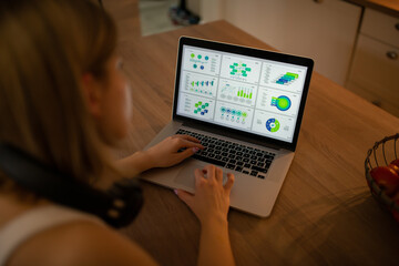 A young woman works from home on her new laptop