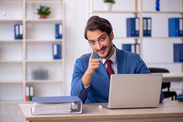 Fototapeta premium Young male employee and too much work in the office