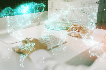 Double exposure of abstract digital world map and hand typing on laptop on background, research and strategy concept