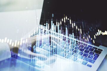 Double exposure of abstract creative financial chart with hand typing on computer keyboard on background, research and strategy concept