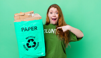 red head pretty woman feeling happy and pointing to self with an excited. recycling concept