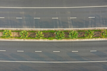 Aerial top view of urban road green belt