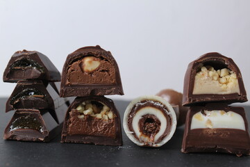 background of candy candy chocolate. sweets in section with fillings of praline ganache with peanuts whole crushed close-up. A day without diet sweet day chocolate