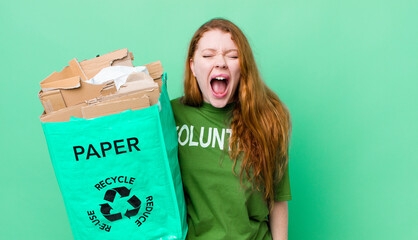 red head pretty woman shouting aggressively, looking very angry. recycling concept
