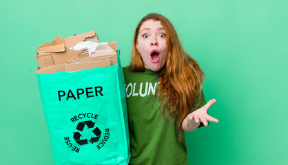 red head pretty woman amazed, shocked and astonished with an unbelievable surprise. recycling...