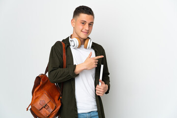 Young caucasian student man isolated on white background pointing finger to the side © luismolinero