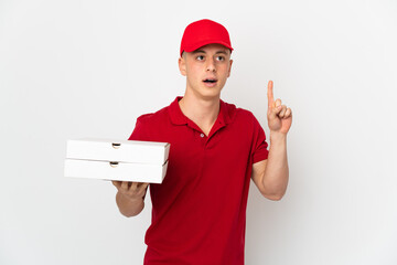 Pizza delivery man with work uniform picking up pizza boxes isolated on white background thinking...