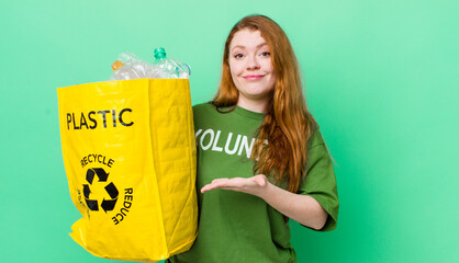 red head pretty woman smiling cheerfully, feeling happy and showing a concept. recycling concept