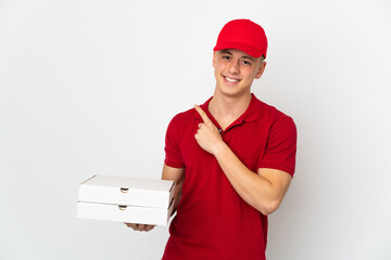 Pizza delivery man with work uniform picking up pizza boxes isolated on white background pointing...
