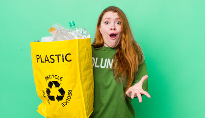 red head pretty woman amazed, shocked and astonished with an unbelievable surprise. recycling...