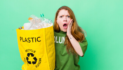 red head pretty woman feeling shocked and scared. recycling concept