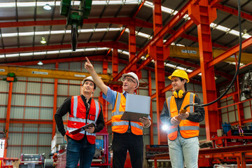 Team of diversity worker inspecting inside the steel manufacturing factory while listening to...