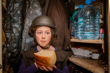 A child in a helmet hides in the basement from the shooting. A girl eats bread in a bomb shelter...