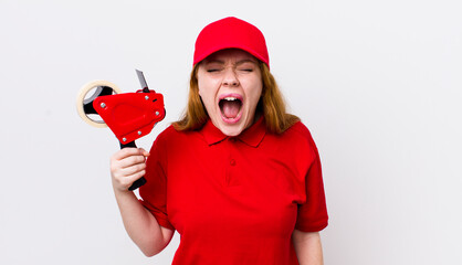 red head pretty woman shouting aggressively, looking very angry. packer employee concept