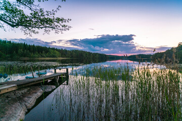 Lake reflecting clouds at sunset © Image Source RF