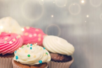 Sweet upcakes with cream cheese decorated with dried cinnamon powder. Homemade pastry