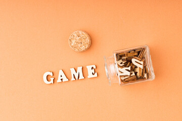 game word from wooden letters on orange background