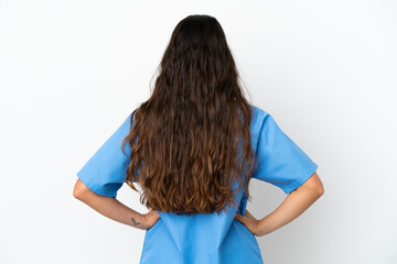 Young surgeon doctor caucasian woman isolated on white background in back position