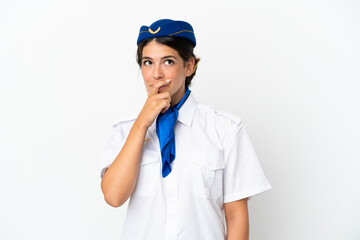 Airplane stewardess caucasian woman isolated on white background having doubts and with confuse face expression