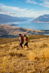 Fototapeta na wymiar New Zealand Male female hikers trekking The Remarkables