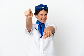 Airplane stewardess caucasian woman isolated on white background points finger at you while smiling