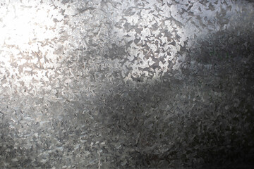 A galvanized metal surface used as a seamless background pattern.