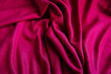 Bright pink, purple drapery fabric. A piece of matter with purple folds.