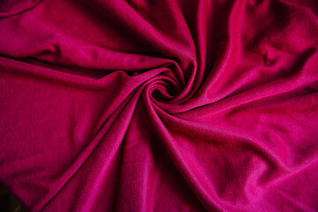 Bright pink, purple drapery fabric. A piece of matter with purple folds.