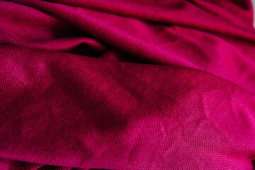 Bright pink, purple drapery fabric. A piece of matter with purple folds.