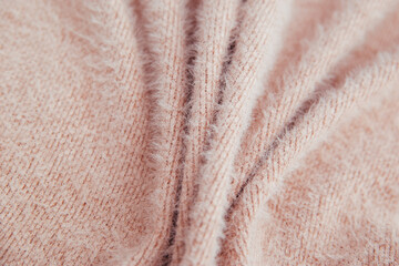 Pink fluffy fabric for drapery. A piece of warm cloth with folds.