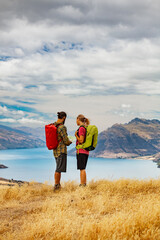 Young hikers map reading Lake Wakatipu New Zealand