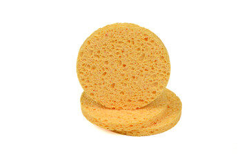 Three round yellow face sponges highlighted on a white background.