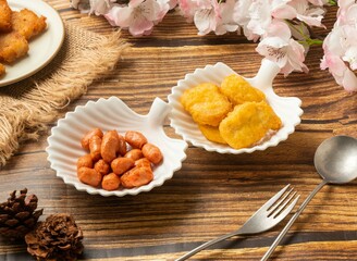 Obraz na płótnie Canvas crispy chicken nuggets with Fried small bean in dish side view on wooden table taiwan style food