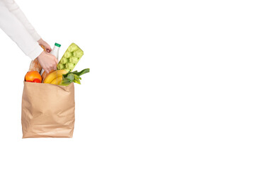 Food delivery, online shopping or donation concept. Grocery store shopping. Courier holds a paper...