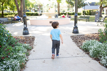 a boy walking to a fountain un winter park Florida Orlando 
