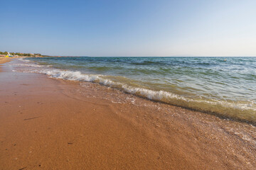 Fototapeta na wymiar Beautiful view of rolling waves of Mediterranean sea on beach. Greece.