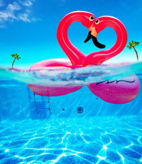 Love concept flamingo rubber buoys kiss in heart shape © Sergey Novikov