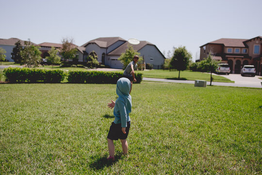 boys playing with a freebee Family Playing Frisbee Pictures, Images and Stock Photos