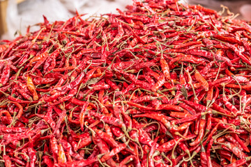 Close up shot of a pile of dried red chili peppers with selective focus