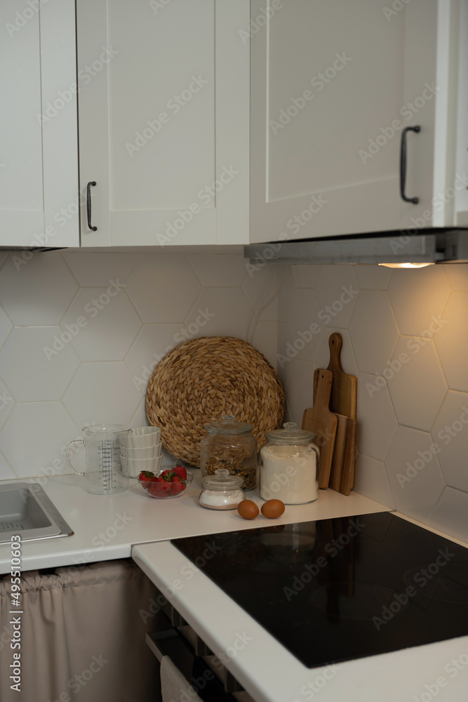 Wall mural The interior of the kitchen of the room, decor with kitchen utensils, white minimalistic for the background.