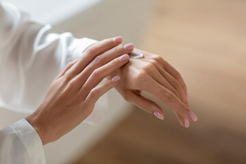 Dry Skin Remedy. Unrecognizable Young Woman Applying Hand Cream, Closeup Shot